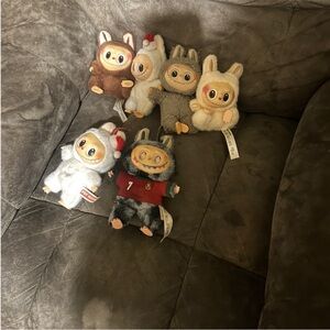 Multiple labubu plush toys with Christian Regalado out fit